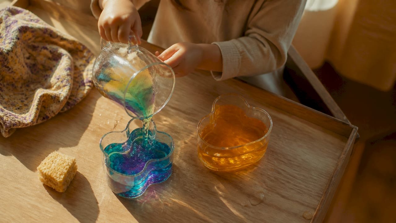 Toddler hands repeating pouring experiment
