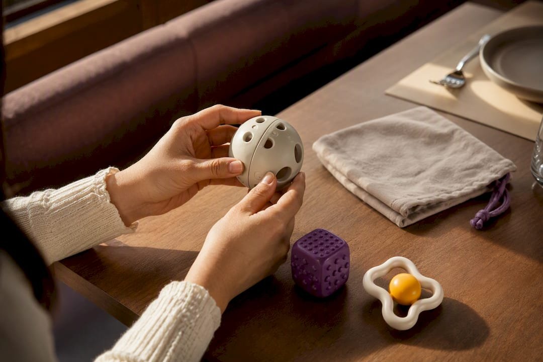 Caregiver checking toddler toys for safety