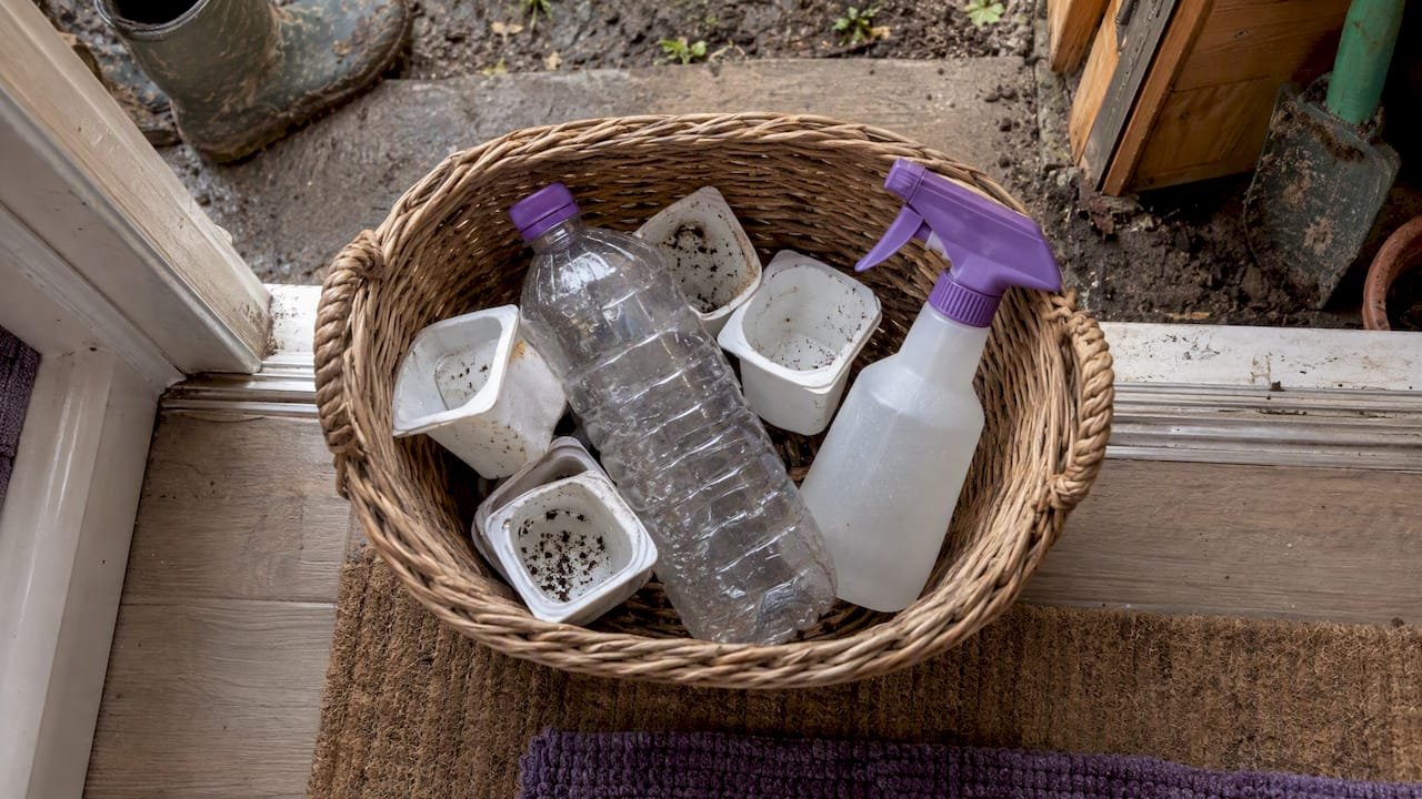 Reused pots and bottles in a toddler tool basket